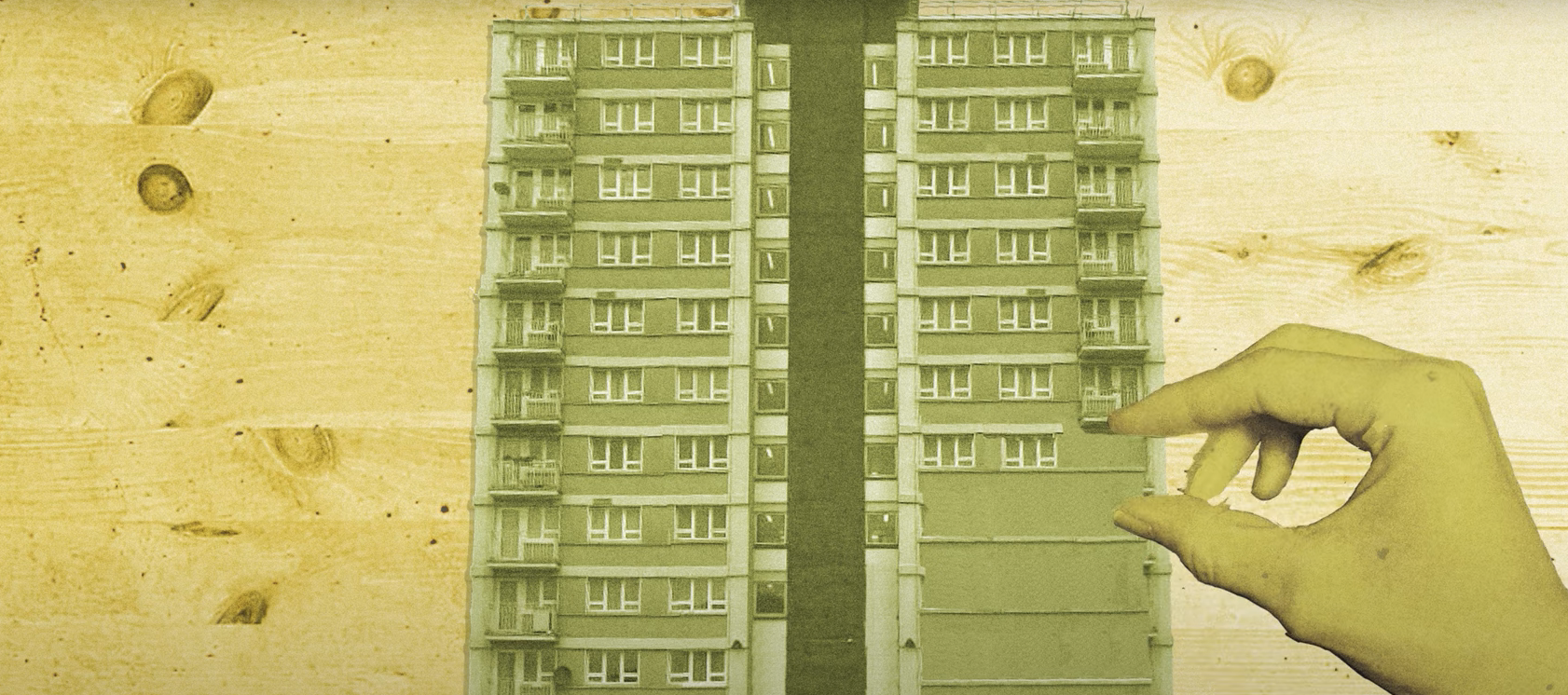 BLock of flats with hand superimposed over the top